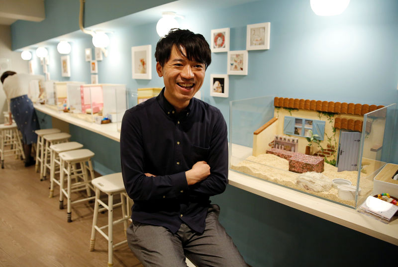 © Reuters. Masaki Shimizu speaks during interview with Reuters at his ChikuChiku cafe in Tokyo