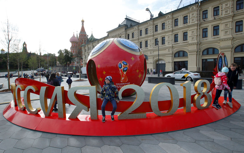© Reuters. FILE PHOTO: People gather near decorations for the upcoming 2018 FIFA World Cup in central Moscow