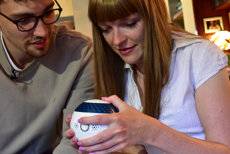 © Reuters. Designer Billy Searle shows his sister Jess how to use 'Mylo', a spherical games controller he has built to help people with disabilities, in London