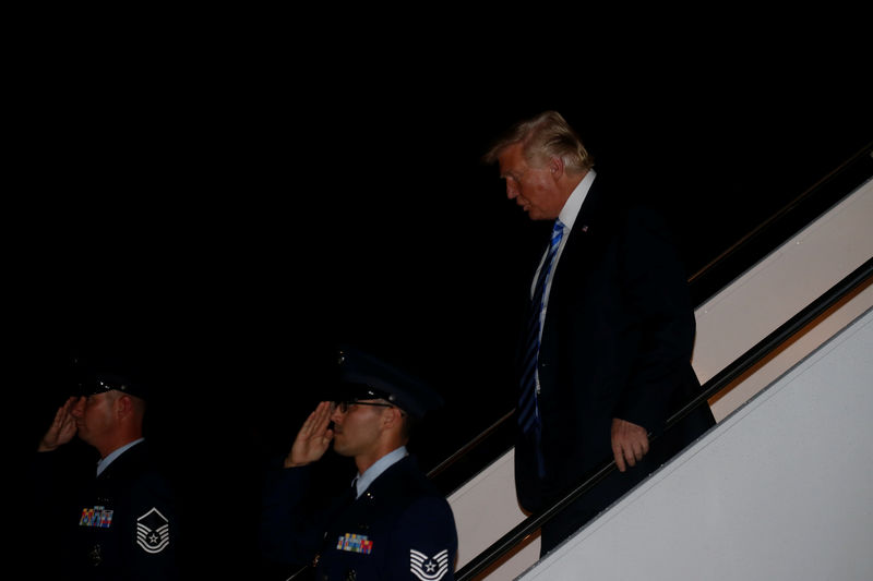 © Reuters. President Donald Trump disembarks from Air Force One at Joint Base Andrews Maryland