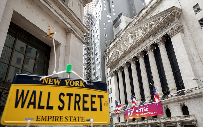 © Reuters. A novelty Wall St. sign is displayed at a stand outside the NYSE in New York