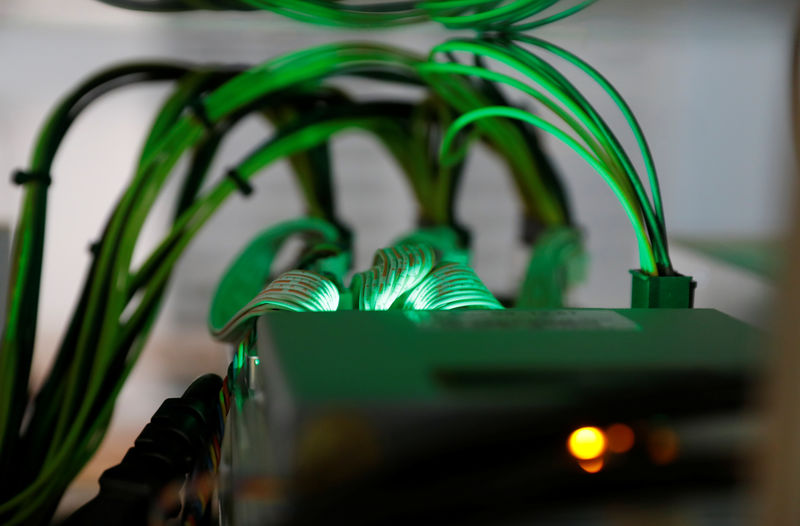 © Reuters. Cables running into cryptocurrency miners are seen at the HydroMiner cryptocurrency farming operation near Waidhofen an der Ybbs