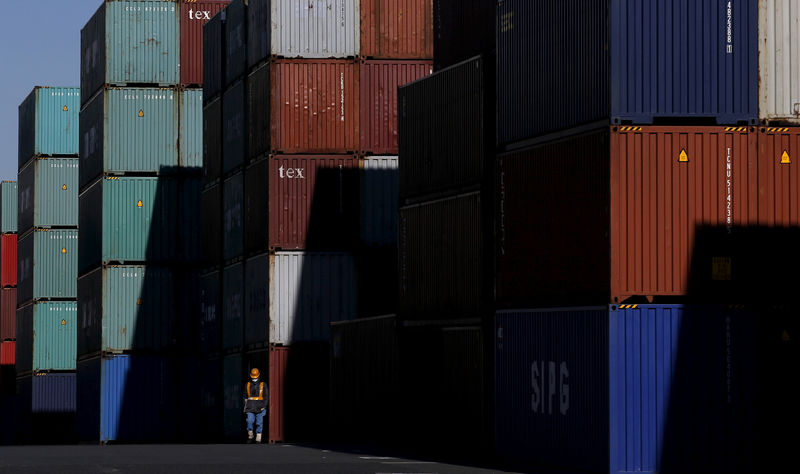 © Reuters. FILE PHOTO: Worker walks in a container area at a port in Tokyo
