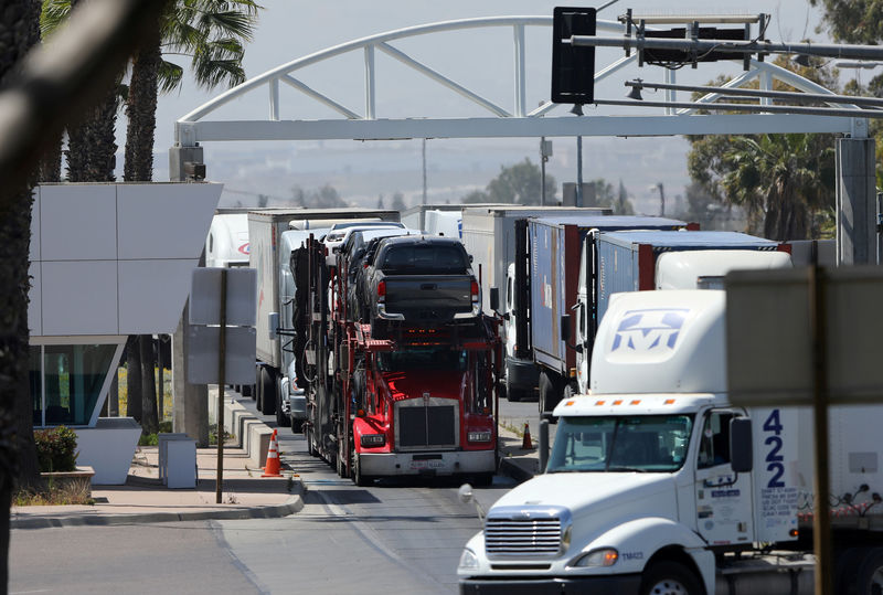 © Reuters. FILE PHOTO: A transport truck hauls new Toyota trucks into the United States from Mexico