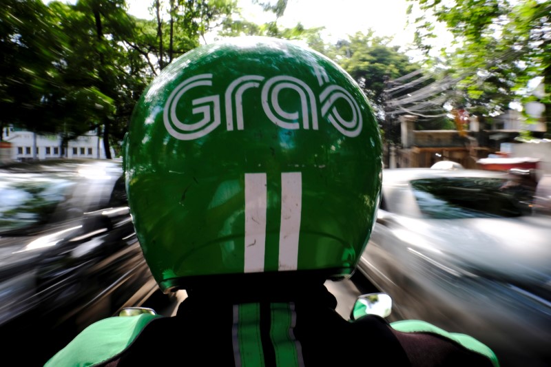 © Reuters. A Grab motor driver is seen in a street in Jakarta