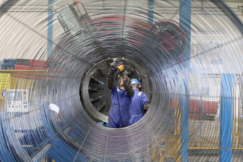 © Reuters. FILE PHOTO: A worker is seen through a pipe at French pipe coating company EUPEC in Sassnitz