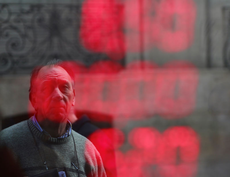 © Reuters. A man looks at a currency exchange electronic board in Buenos Aires' financial district