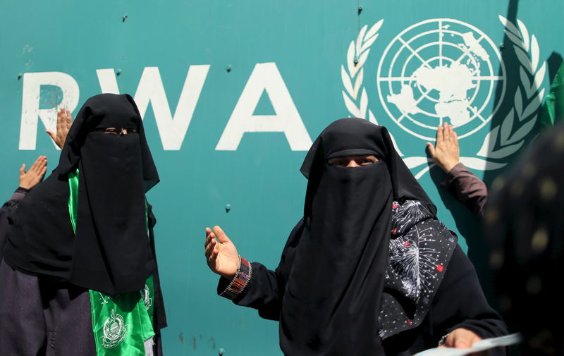 © Reuters. Palestinian women take part in a protest against possible reductions of the services and aid offered by UNRWA in front of UNRWA headquarters in Gaza City