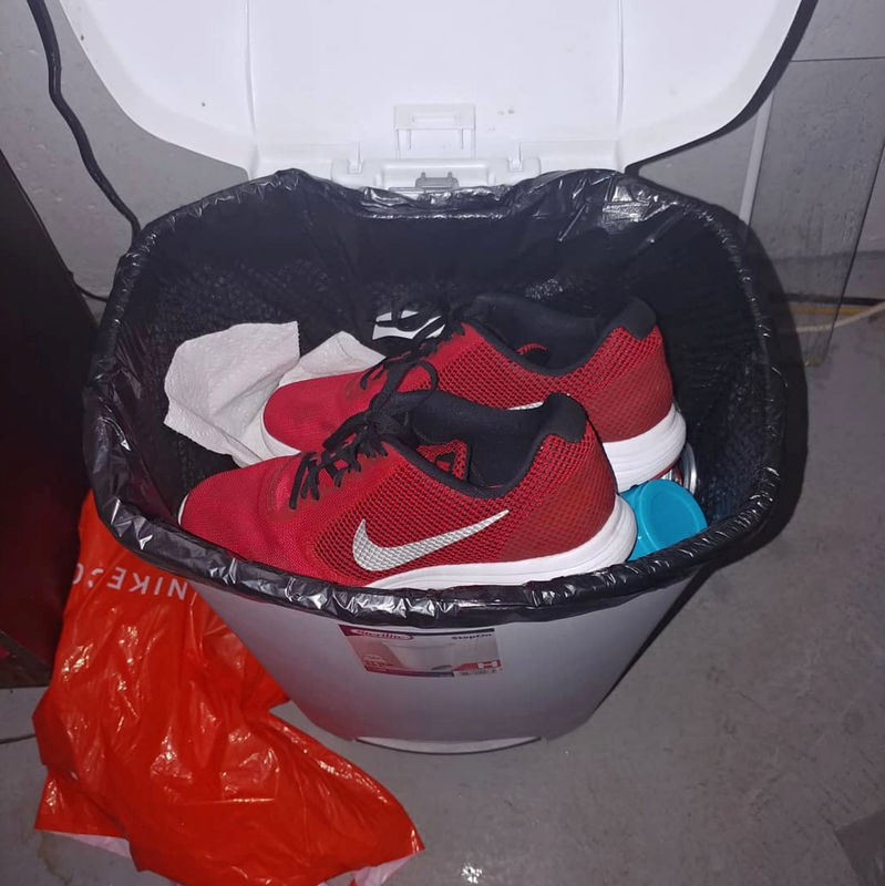 © Reuters. Nike sneakers are seen in the garbage bin in Oklahoma