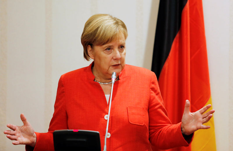 © Reuters. German Chancellor Angela Merkel addresses a news conference at the presidential villa in Abuja