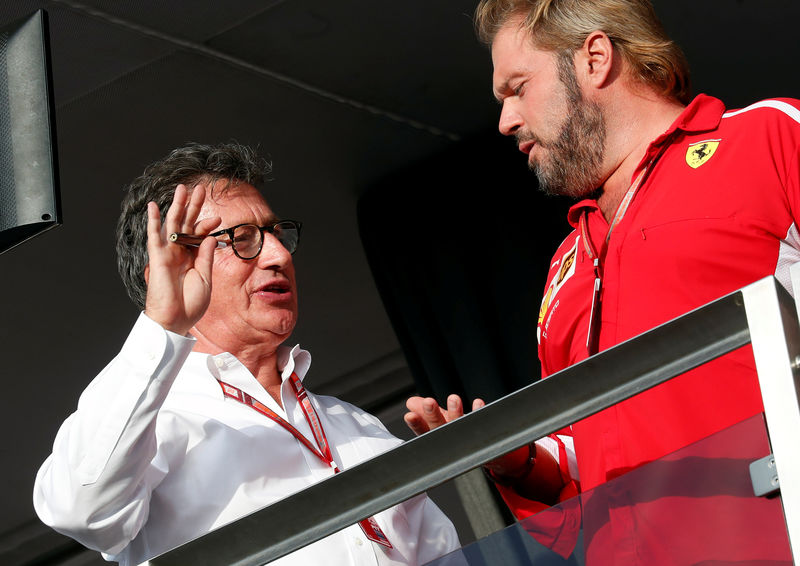 © Reuters. New Ferrari's CEO Louis Carey Camilleri speaks with a technician after the Italian Formula One Grand Prix at the Monza racetrack