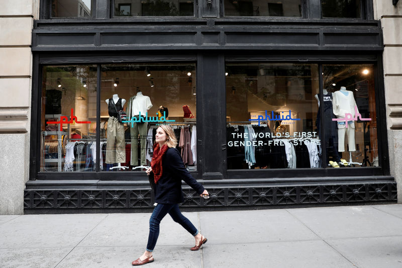 © Reuters. A woman walks past Phluid, a new retail shop billed as "The world's first gender-free store" in New York