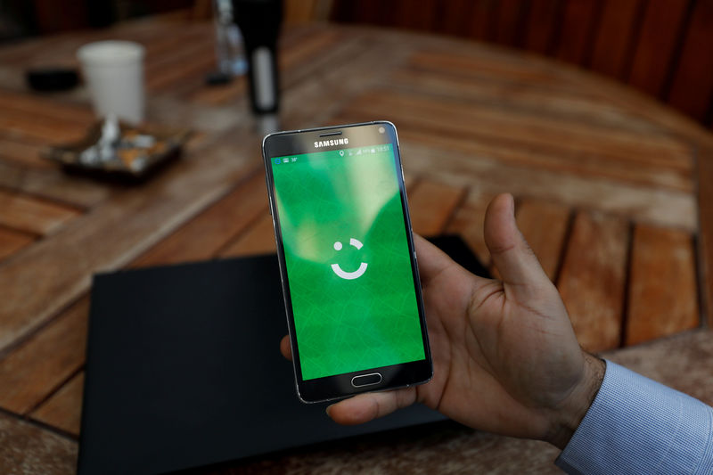 © Reuters. FILE PHOTO: Employee shows the logo of Careem on his mobile in his office in the West Bank city of Ramallah