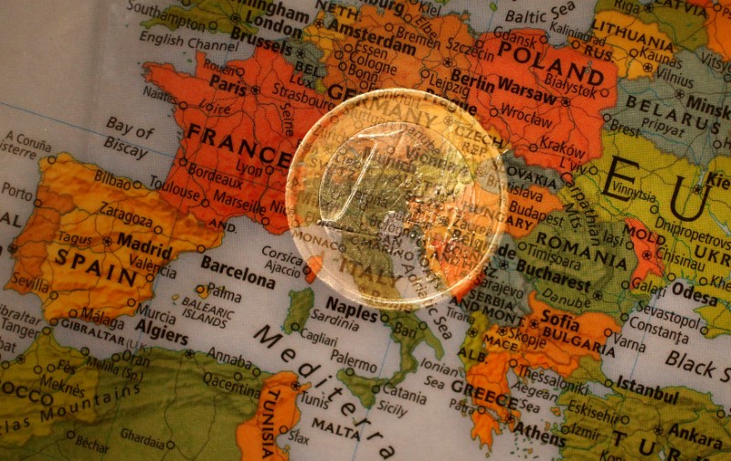 © Reuters. FILE PHOTO: A picture illustration taken with the multiple exposure function of the camera shows a one Euro coin and a map of Europe