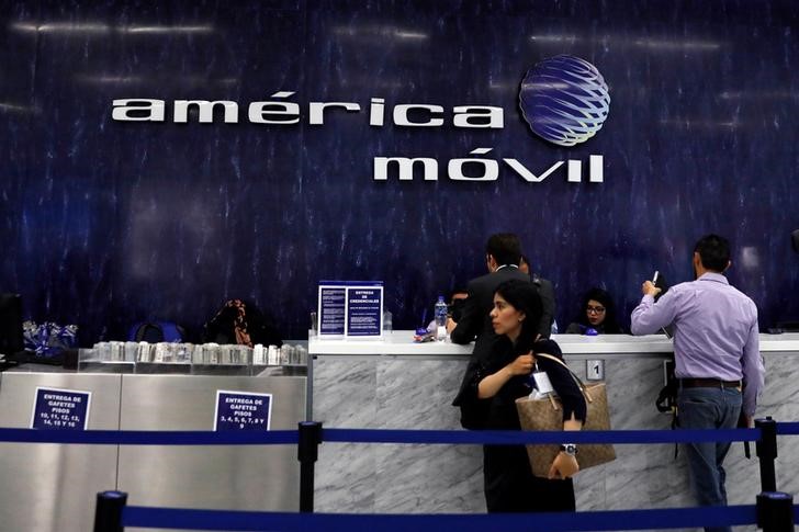 © Reuters. The logo of America Movill is seen on the wall at the company's corporate offices in Mexico City