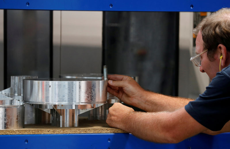 © Reuters. FILE PHOTO: Worker examines an aluminium component inside Produmax in Shipley