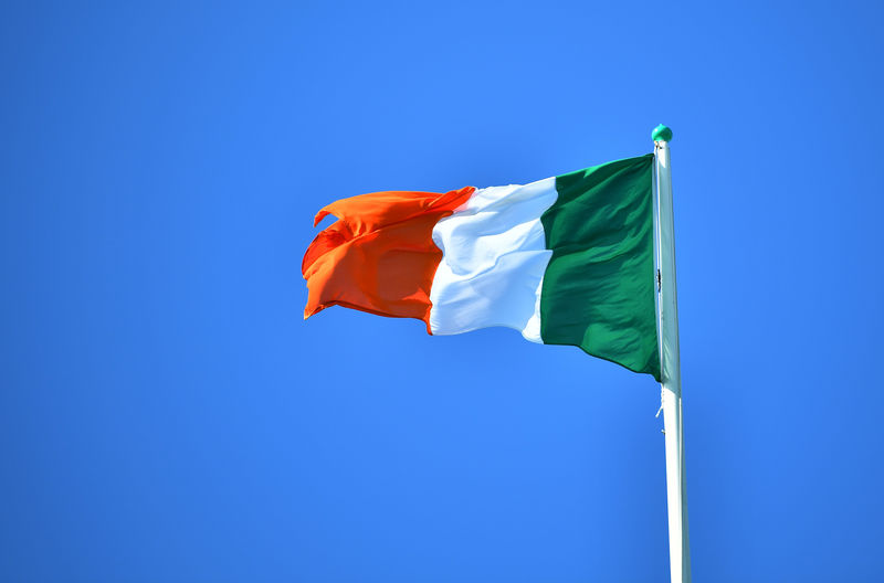 © Reuters. National flag of Ireland flies above the President's residence, ahead of the arrival of Pope Francis, in Dublin