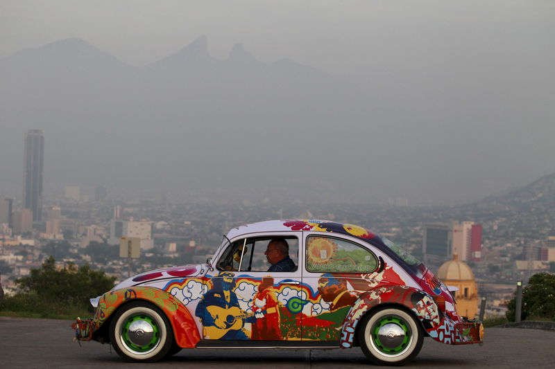 © Reuters. Penia drives his VW Beetle 1995, locally called "Vocho", through the streets of Monterrey