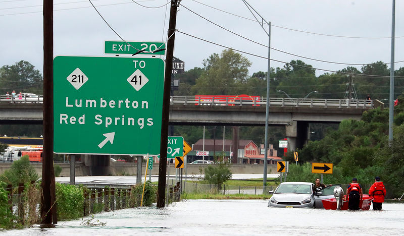 © Reuters. Members of the Coast Guard help a stranded motorist in the flood waters caused by Hurricane Florence in Lumberton.