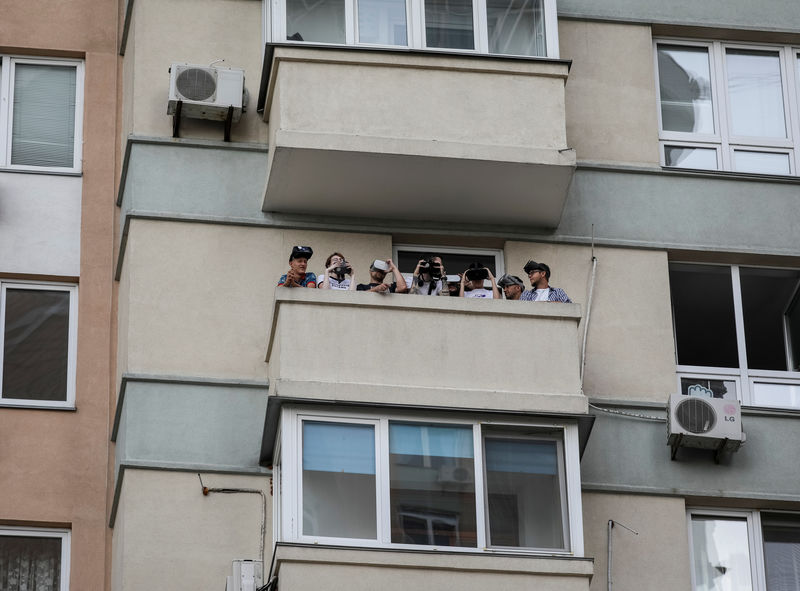 © Reuters. Staff members of the New Cave Media pose for a picture on the balcony of their office in Kiev