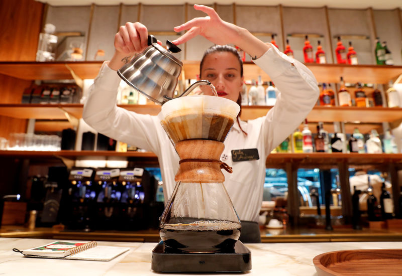 © Reuters. FILE PHOTO: An employee prepares a coffee inside the new Starbucks Reserve Roastery flagship in downtown Milan