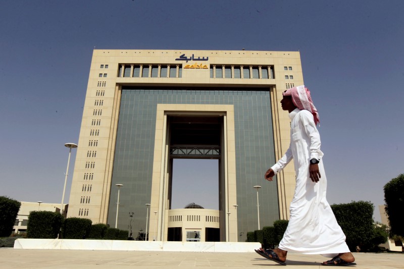 © Reuters. FILE PHOTO: A man walks past the headquarters of Saudi Basic Industries Corp (SABIC) in Riyadh