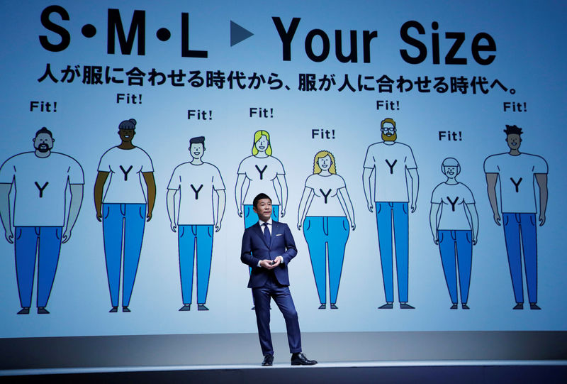 © Reuters. FILE PHOTO: Maezawa, the chief executive of Zozo speaks in front of a projection about Zozosuit at an event launching the debut of its formal apparel items, in Tokyo