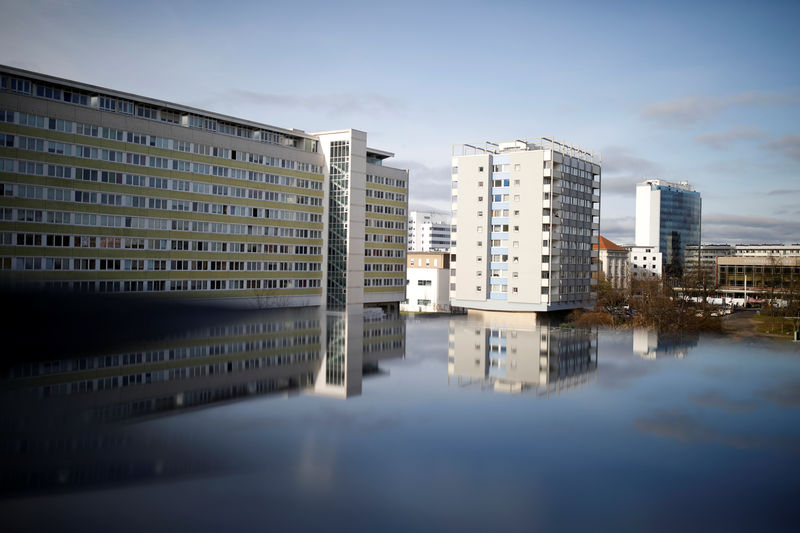 © Reuters. Residential buildings are reflected in a puddle in Cottbus