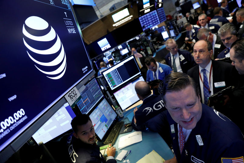 © Reuters. FILE PHOTO: The AT&T logo is seen on a monitor on the NYSE floor.