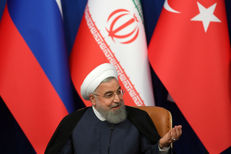 © Reuters. Iranian President Rouhani speaks during a news conference with President Erdogan of Turkey and Putin of Russia following their meeting in Tehran