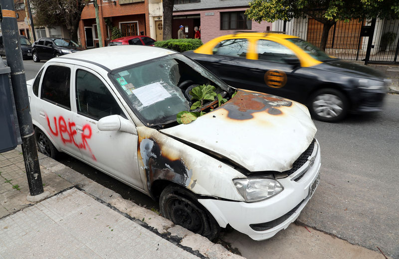 © Reuters. A car that was vandalised because it was allegedly used as an Uber vehicle is seen in Buenos Aires