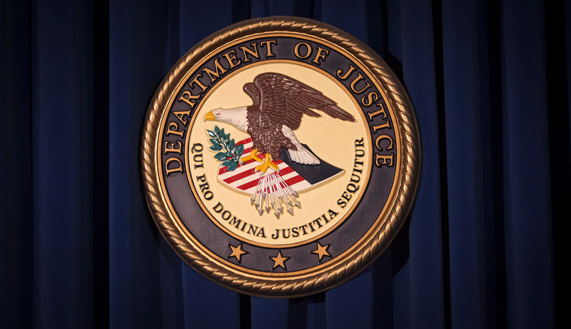© Reuters. FILE PHOTO: The DOJ logo is pictured on a wall after a news conference in New York