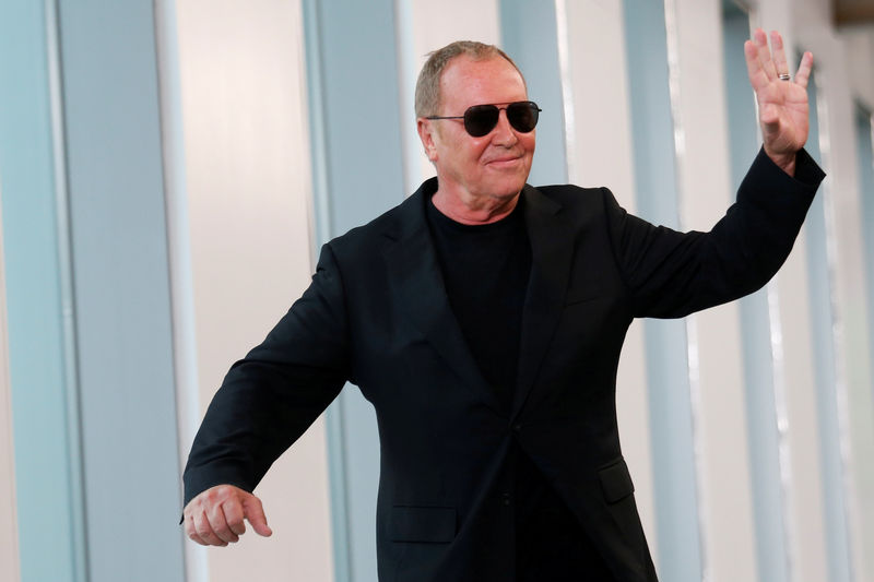 © Reuters. FILE PHOTO: Designer Michael Kors waves after the showing of his Spring/Summer 2019 collection during New York Fashion Week in New York