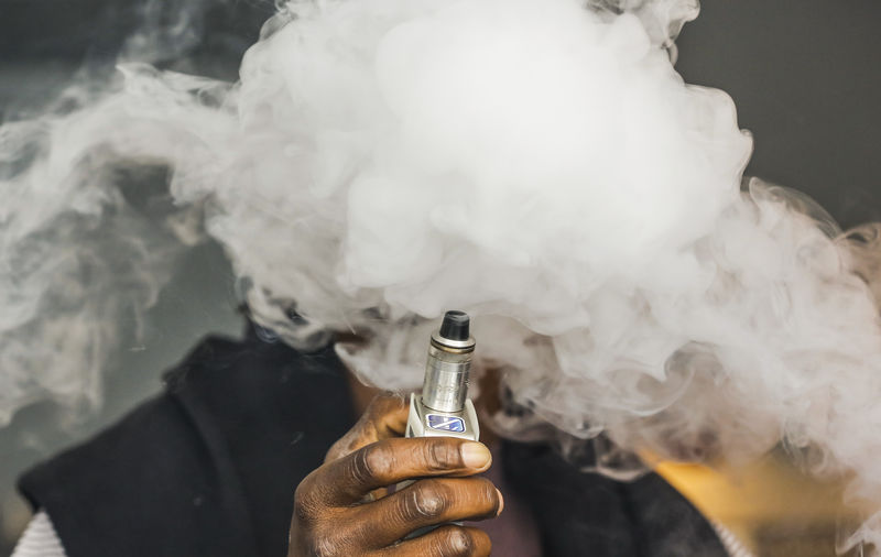 © Reuters. A man smokes an electronic cigarette vaporizer, also known as an e-cigarette, in Toronto