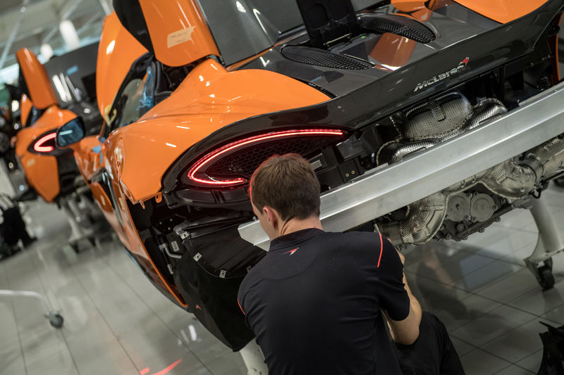 © Reuters. FILE PHOTO: An employee works on a McLaren 720S on the factory floor of the McLaren Automotive Production Centre Woking
