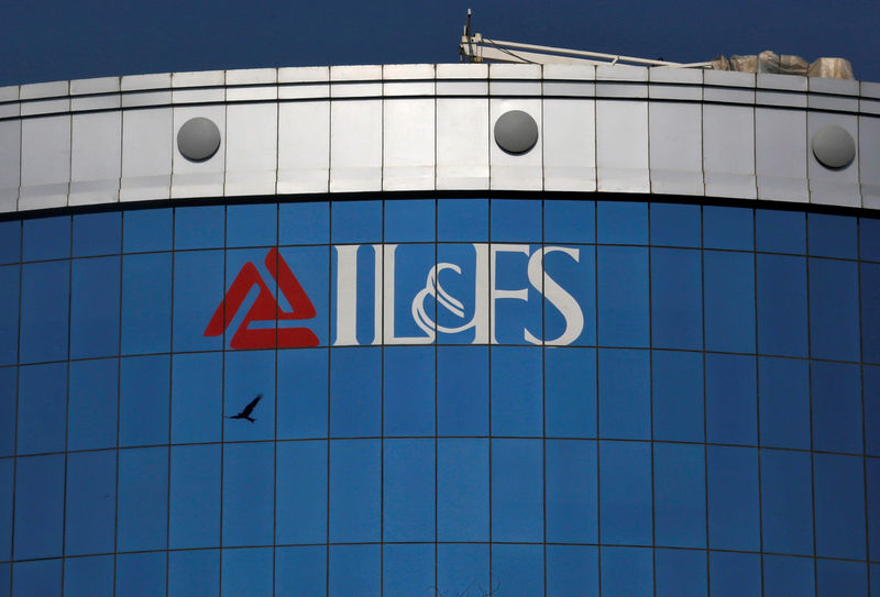 © Reuters. FILE PHOTO: A bird flies next to the logo of IL&FS installed on the facade of a building at its headquarters in Mumbai