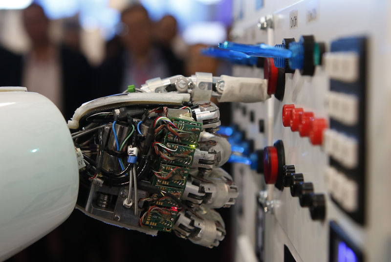 © Reuters. The hand of humanoid robot AILA (artificial intelligence lightweight android) operates a switchboard during a demonstration by the German research centre for artificial intelligence at the CeBit computer fair in Hanover