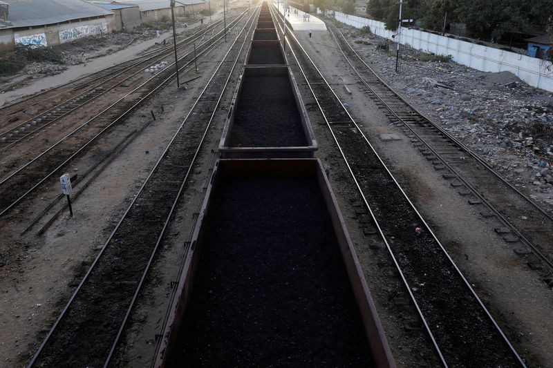 © Reuters. FILE PHOTO: A cargo train loaded with coal dust, moves past the port area near City Station in Karachi