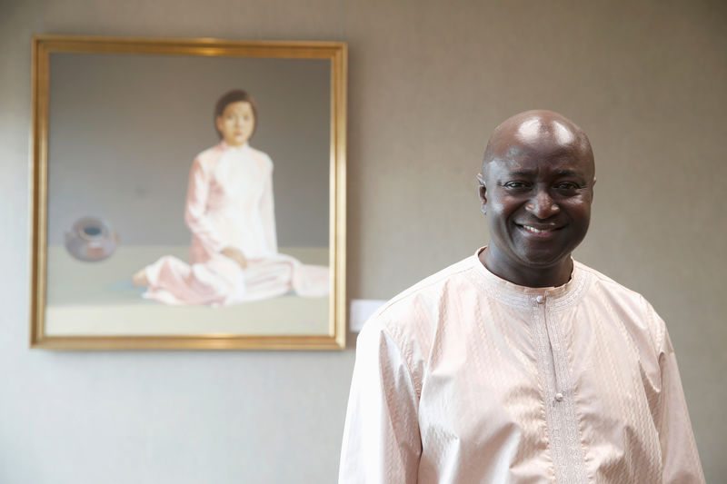 © Reuters. Lamin Manjang, chief executive of Standard Chartered Kenya bank poses for a picture during an interview in Nairobi