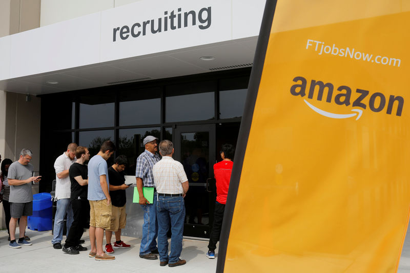 © Reuters. FILE PHOTO: Job seekers line up to apply during "Amazon Jobs Day" at the Amazon.com Fulfillment Center in Fall River