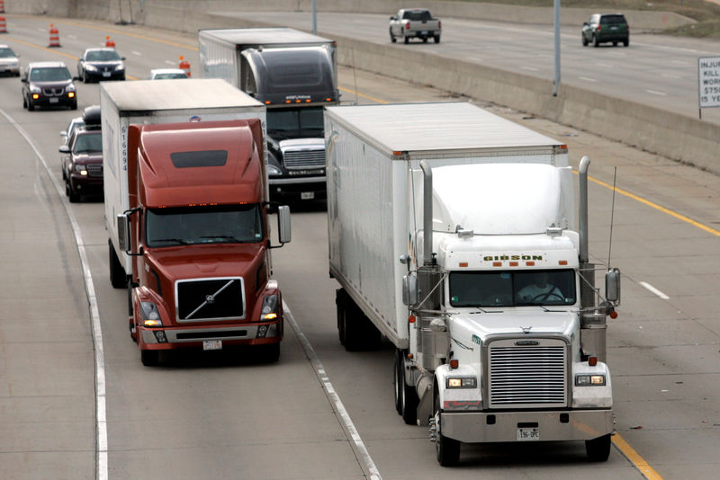 © Reuters. FILE PHOTO: Two freight trucks are driven on the Fisher freeway in Detroit, Michigan