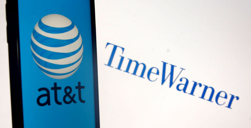 © Reuters. FILE PHOTO: Smartphone with AT&T logo is seen in front of displayed Time Warner logo in this picture illustration