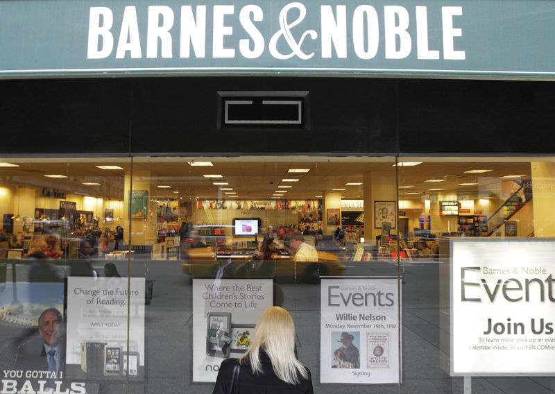 © Reuters. FILE PHOTO: A woman looks in from a window panel of a Barnes and Noble store in New York