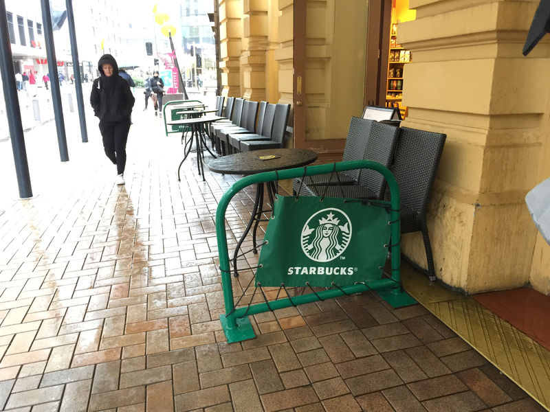 © Reuters. A pedestrian walks past a Starbucks cafe in central Wellington