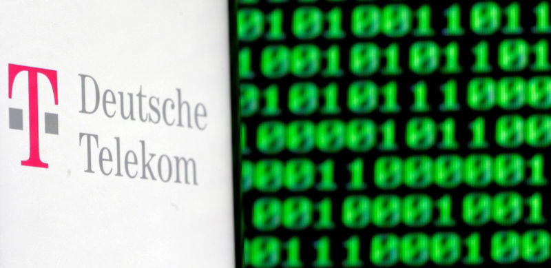 © Reuters. FILE PHOTO: A photo illustration shows a German Deutsche Telekom logo on smartphone in front of a displayed cyber code