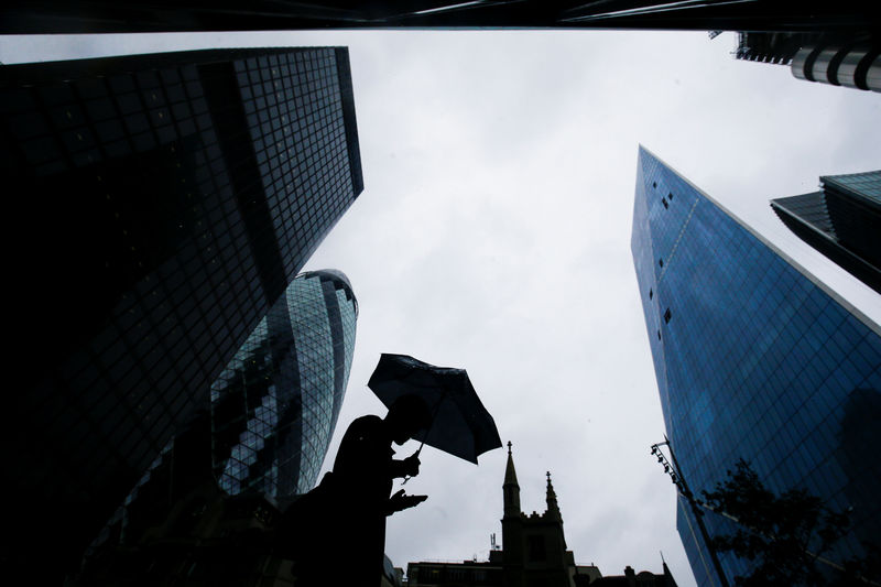 Â© Reuters. FILE PHOTO: A person walks through the financial district during rainy weather in London