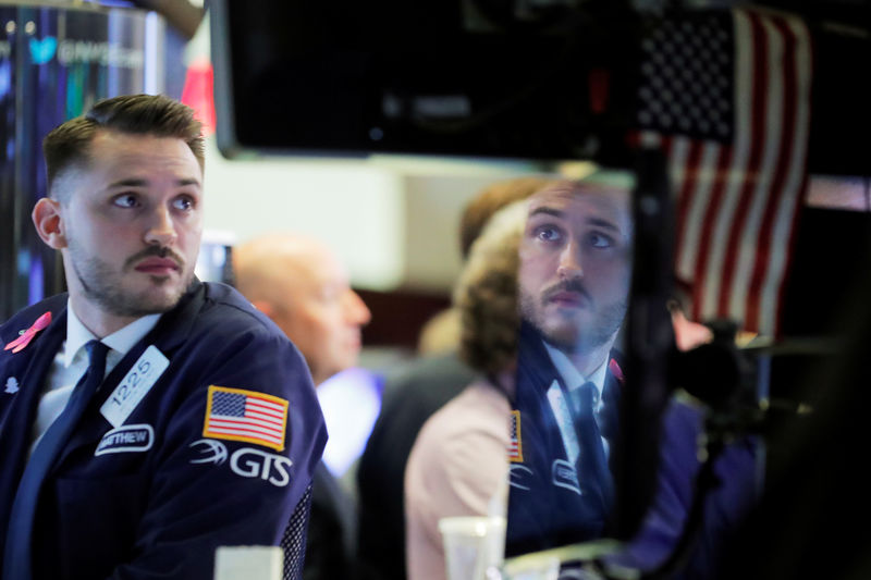 © Reuters. A trader working on the floor of the New York Stock Exchange (NYSE) is reflected on a monitor in Manhattan in New York