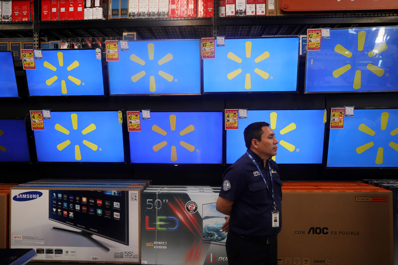 © Reuters. A store clerk is seen in an aisle during the opening of a new Walmart Store in San Salvador