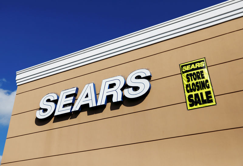 © Reuters. FILE PHOTO:    A store closing sale sign is posted next to a Sears logo in New Hyde Park, New York