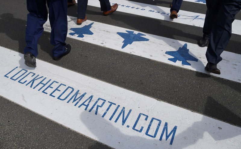 © Reuters. Trade visitors are seen walking over a road crossing covered with Lockheed Martin branding at Farnborough International Airshow in Farnborough, Britain